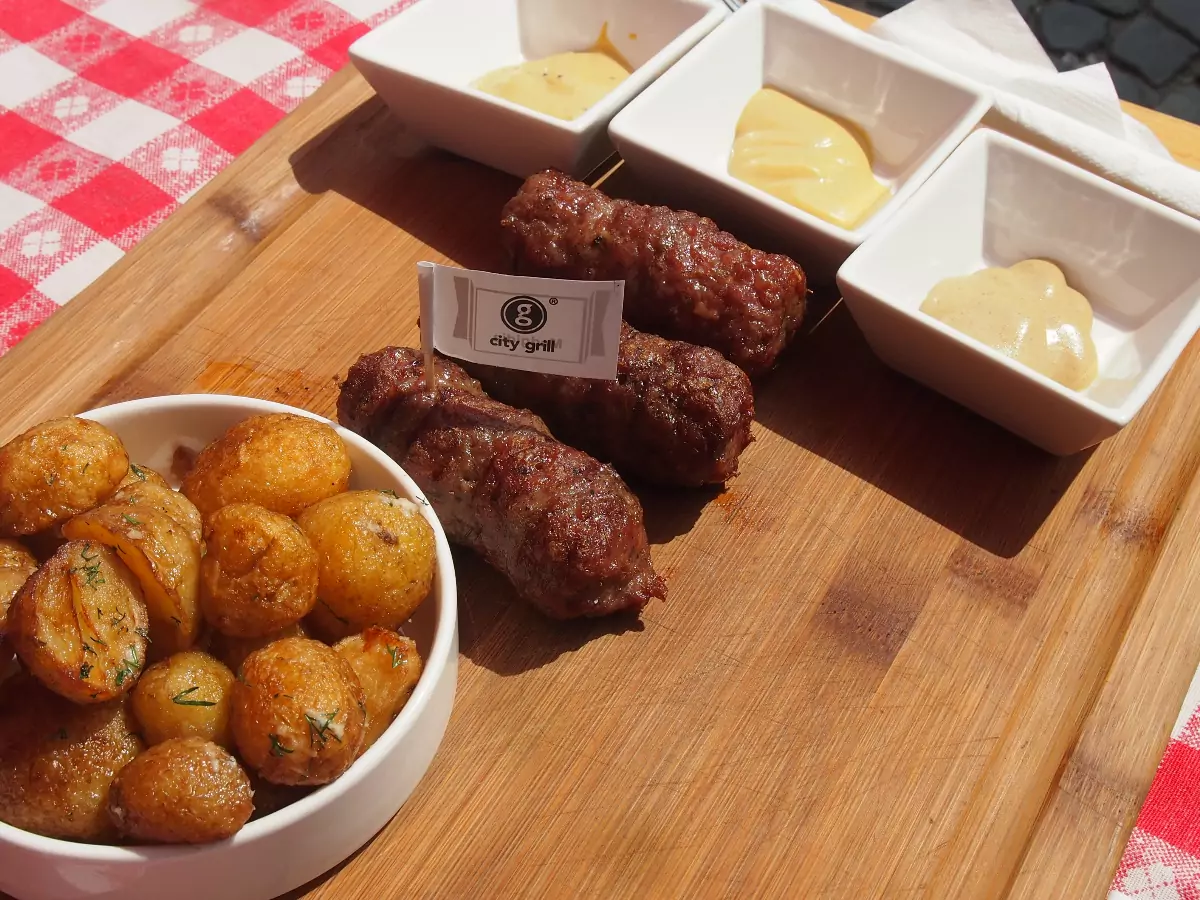 mititei served for lunch with fried baby potatoes and a selection or Romanian mustards